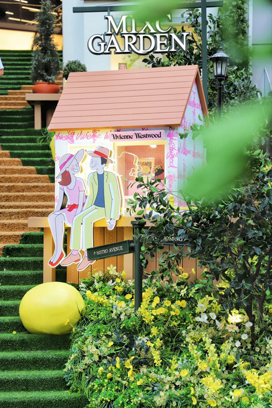 drawn couple sitting in front of small house 
