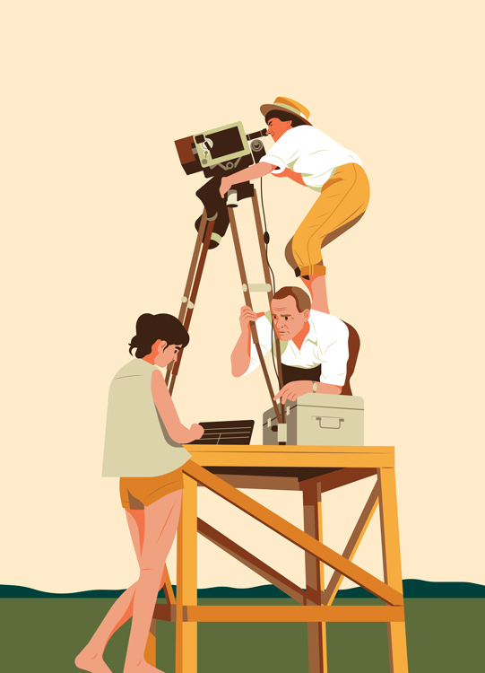 three people filming, cameraman standing on a table 