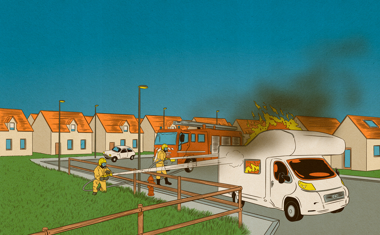 firefighters extinguish a burning caravan 