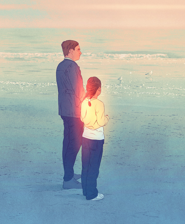 father and daughter looking at the sea in evening light 